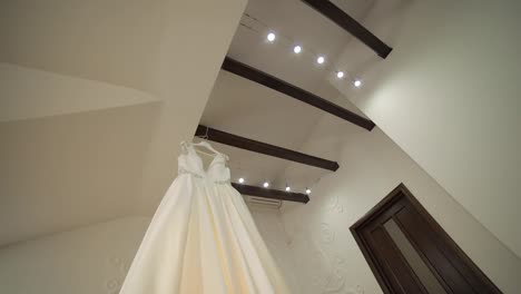 The-bride's-dress-hangs-under-the-ceiling.-Very-beautiful-and-elegant.-Wedding