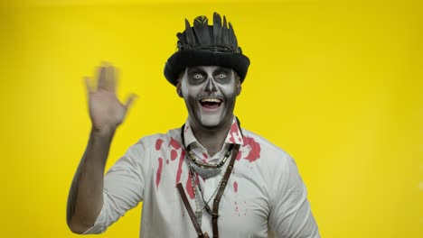 Sinister-man-with-professional-Halloween-skeleton-makeup-greeting-someone,-say-hello,-hi,-welcome