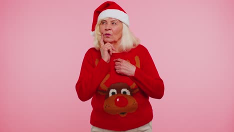 Grandmother-in-Christmas-sweater-make-gesture-raises-finger-came-up-with-creative-plan-good-idea