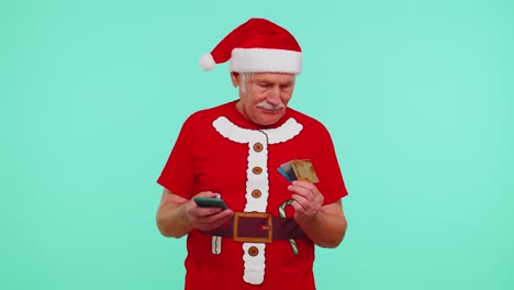 Christmas-grandfather-using-credit-bank-card,-smartphone-while-transferring-money-shopping-online