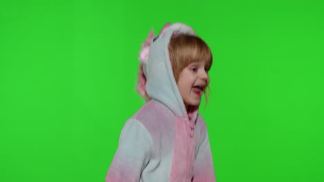 Child-girl-in-unicorn-pajamas-making-silly-funny-faces,-fooling-around,-dancing-on-chroma-key