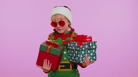Girl-toddler-kid-Christmas-Santa-Claus-Elf-holds-two-gift-boxes-in-hands,-shopping-holidays-sale