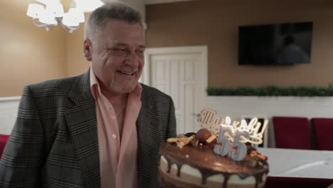 Happy-respectable-old-man-holding-cake.-Celebrating-birthday-anniversary