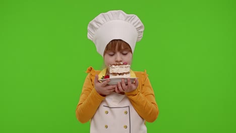Child-girl-kid-dressed-as-professional-cook-chef-showing-eating-tasty-handmade-strawberry-cake
