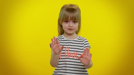 Kid-child-girl-warning-with-admonishing-finger-gesture-sign,-saying-no,-be-careful,-avoid-danger