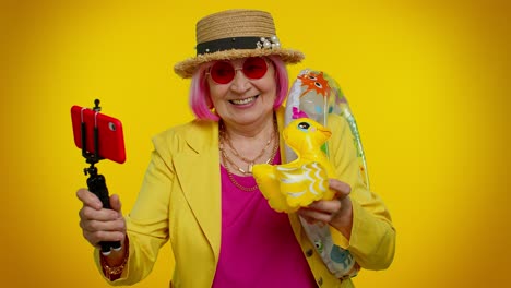 Mature-grandmother-traveler-blogger-in-sunglasses,-taking-selfie-on-mobile-phone,-video-call-online