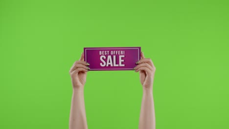 Best-Offer-Sale-advertisement-inscription-on-paper-sheet-in-womans-hands-on-chroma-key.-Slow-motion