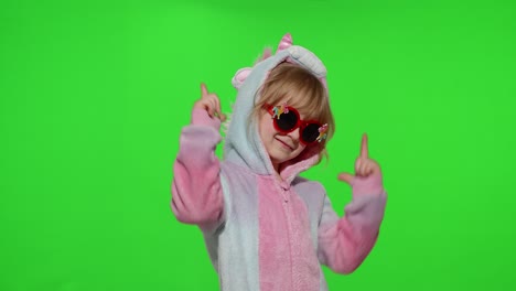 Little-child-girl-smiling,-dancing,-making-gun-gesture-with-hands-in-unicorn-pajamas-on-chroma-key