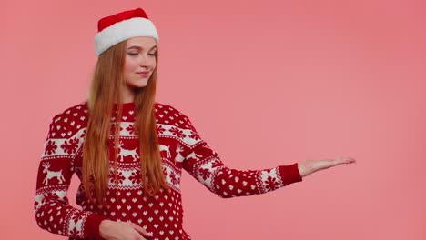 Woman-wears-red-New-Year-sweater-deer-showing-thumbs-up-and-pointing-at-on-blank-advertisement-space