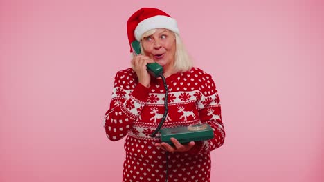 Mature-Christmas-grandmother-woman-talking-on-wired-vintage-telephone-of-80s,-hey-you-call-me-back