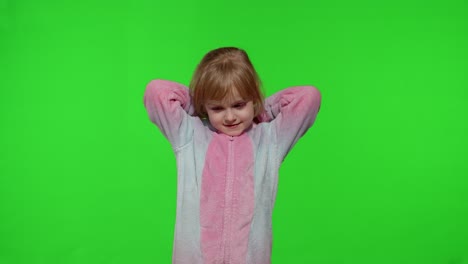 Child-girl-in-unicorn-pajamas-making-silly-funny-faces,-fooling-around,-showing-tongue-on-chroma-key