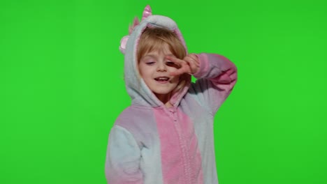 Little-blonde-child-girl-smiling,-dancing,-celebrating-in-unicorn-pajamas-costume-on-chroma-key