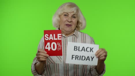 Senior-grandmother-showing-Black-Friday,-40-Percent-Off-discount-advertisement-banners.-Chroma-key