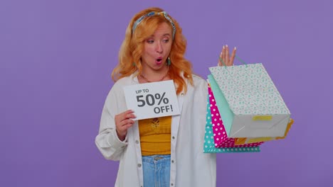 Cheerful-redhead-girl-showing-shopping-bags,-Up-To-50-Percent-Off-inscriptions-banner,-Black-Friday
