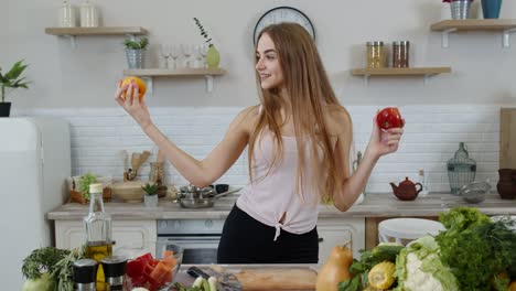 Girl-recommending-eating-raw-vegetable-food.-Showing-tomatoes-in-hands.-Weight-loss-and-diet-concept