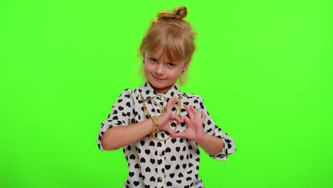 Smiling-child-girl-makes-heart-gesture-demonstrates-love-sign-expresses-good-feelings-and-sympathy