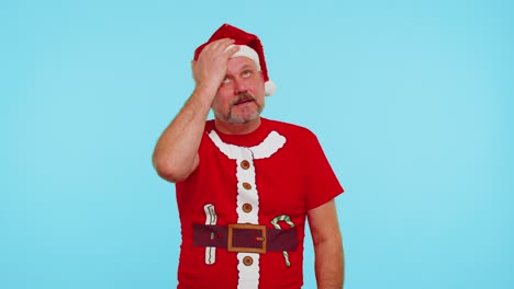 Upset-man-in-Christmas-red-t-shirt-making-face-palm-gesture,-feeling-bored,-disappointed,-bad-result