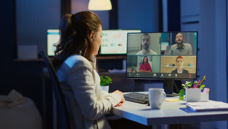 Employee-discussing-with-partners-online-using-webcam-at-night