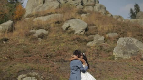 Groom-with-bride-near-mountain-hills.-Wedding-couple.-Happy-family-in-love