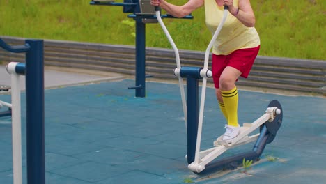 Senior-woman-grandfather-70-years-old-doing-sport-training-exercising-workout-on-orbitrek-playground