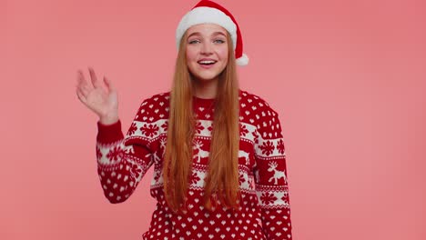 Woman-in-Christmas-sweater-waves-hand-palm-in-hello-gesture-welcomes-someone-to-celebrate-New-Year