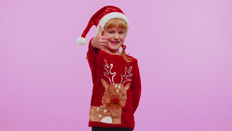 Funny-girl-in-red-New-Year-sweater-raises-thumbs-up-agrees-something-good,-like,-violet-background