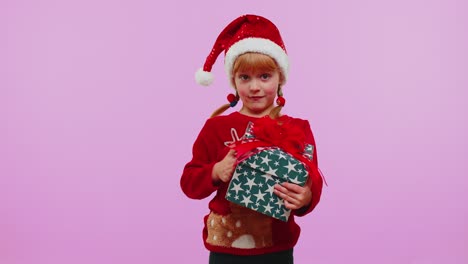 Happy-teen-toddler-girl-kid-wears-red-Christmas-sweater-presenting-Christmas-gift-box,-shopping-sale
