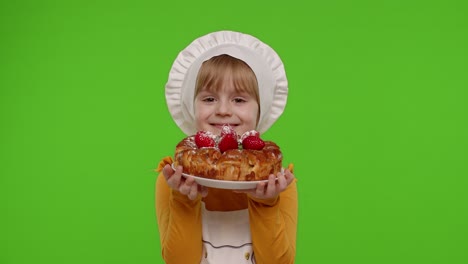 Child-girl-kid-dressed-as-cook-chef-sprinkle-strawberry-cake-with-icing-sugar,-chroma-key-background