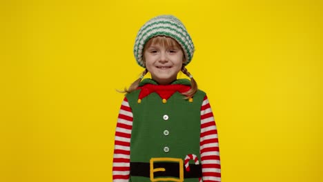 Kid-girl-in-Christmas-elf-Santa-helper-costume-dancing,-performing-dab-dance,-internet-meme-gesture