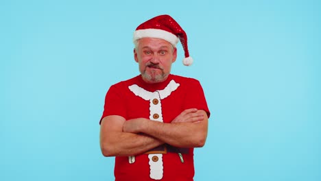 Confused-man-in-t-shirt-Santa-Christmas-hat-pointing-fingers-himself-ask-say-who-why-me-no-thanks