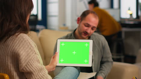 Manager-woman-talking-with-coworker-holding-tablet-with-green-screen