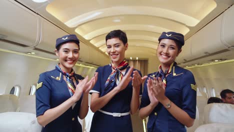 Cabin-crew-clapping-hands-in-airplane