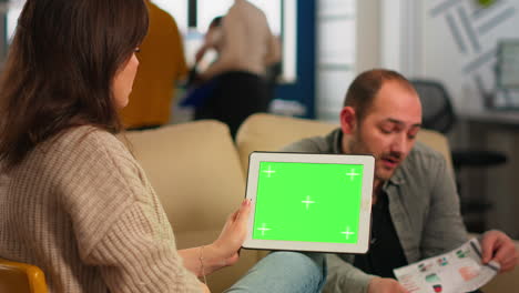 Business-people-analysing-financial-statistics,-holding-tablet-with-green-screen