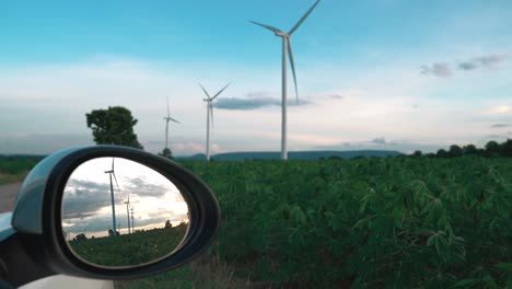Progressive-ideal-of-wind-turbine-reflected-in-side-mirror-of-electric-vehicle.