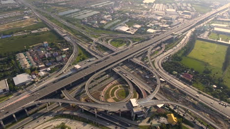 Aerial-View-of-Highway-Road-Interchange-with-Busy-Urban-Traffic-Speeding-on-Road
