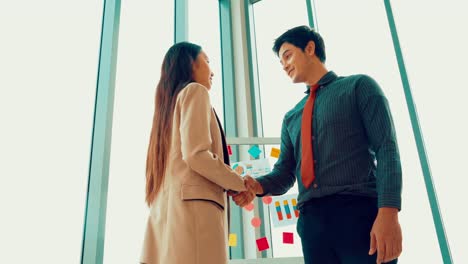 Business-people-handshake-in-corporate-office