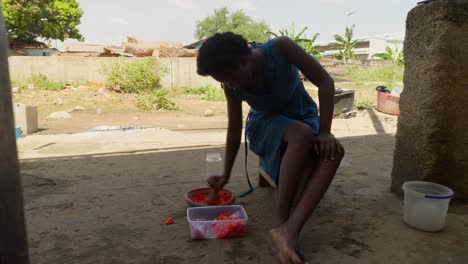 Mujer-Moliendo-Pimienta-Con-Mortero,-Parte-Del-Plato-Tradicional-De-Ghana,-Banku