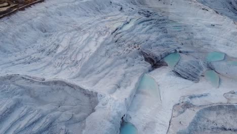 Aerial-view-of-limestone-formations-and-travertine-pools-in-Pamukkale,-Turkey