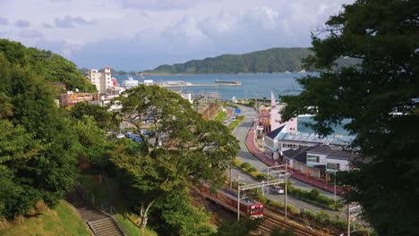 Toba-City-in-Mie,-Train-Passing-Peaceful-Japanese-Coastal-Town