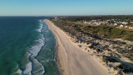Stunning-aerial-of-clean-sandy-beach-and-grassy-sand-dunes