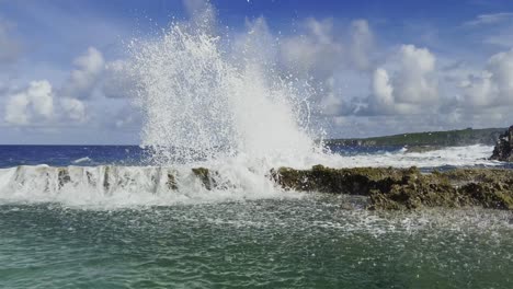 Pan-shot-of-waves-crashing-on-rocks