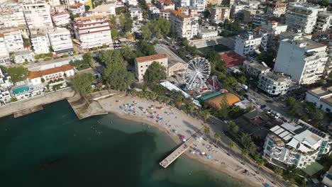 Aerial-View-of-Beach,-Ferris-Wheel-in-Downtown-Saranda-,-Albanian-Riviera