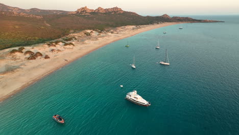 Luxury-yachts-at-the-anchorage-in-Bay-of-Roccapina-in-Corsica-during-sunset