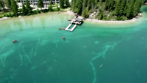 Hotel-Lago-di-Braies-on-shoreline-of-scenic-Pragser-Wildsee,-aerial