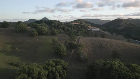 Aerial:-Affluent-estate-home-on-rolling-hill-countryside-of-NSW,-AUS
