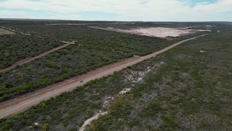 Dusty-highway-through-sandy-terrain-in-Western-Australia---Australia