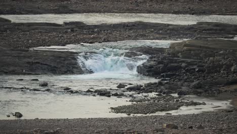 Waterfall-flowing-through-rocky-rundra