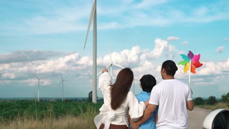 Concept-of-progressive-happy-family-at-wind-farm-with-electric-vehicle.