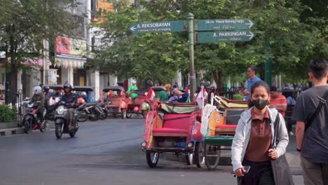 Traditional-pedicab-parked-on-the-roadside-of-Malioboro-Street,-Yogyakarta,-Indonesia