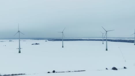 Wind-farm-in-winter,-the-blades-rotate-and-generate-electricity-for-consumers